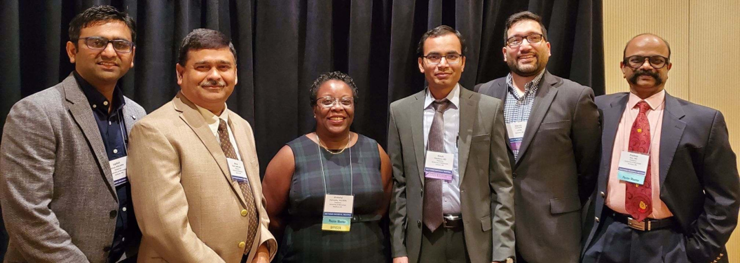 Group of six medical faculty members at a conference.